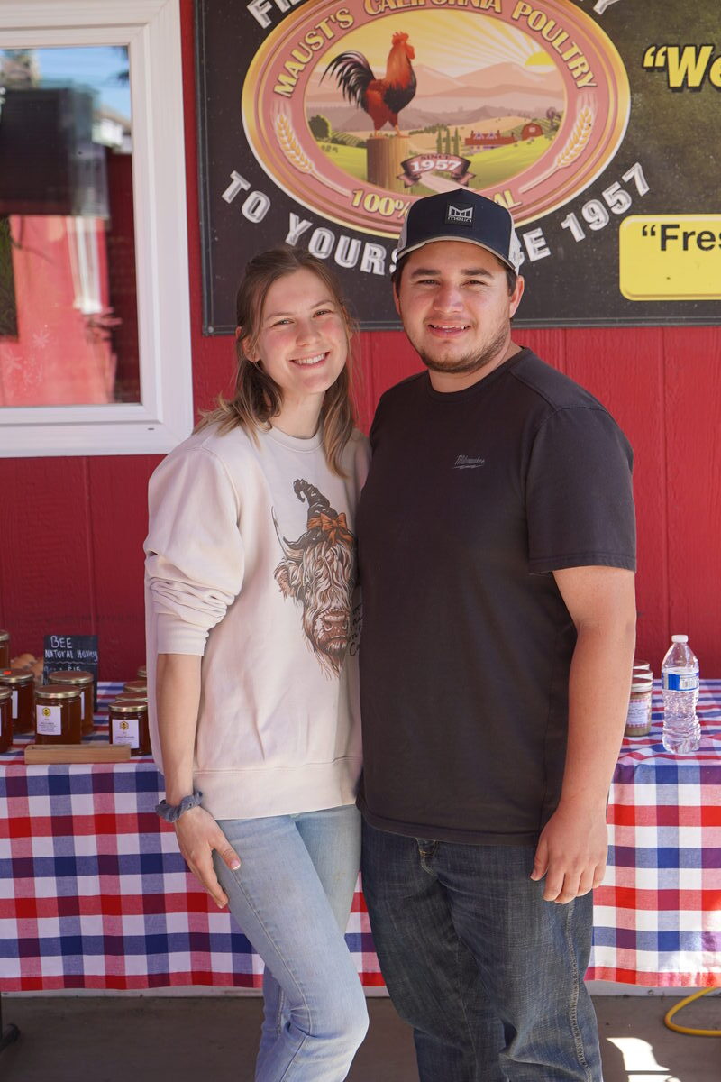 Maust family members in front of the farm sign